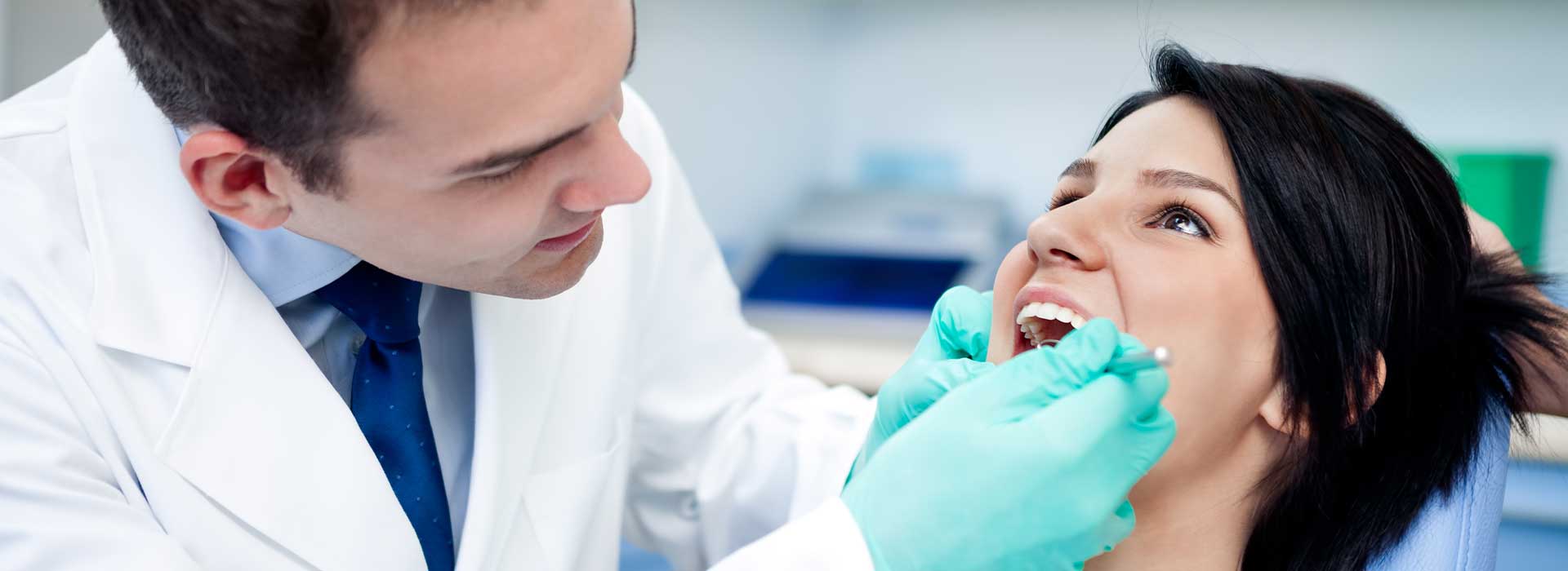 The dentist doing a dental exam for his patient