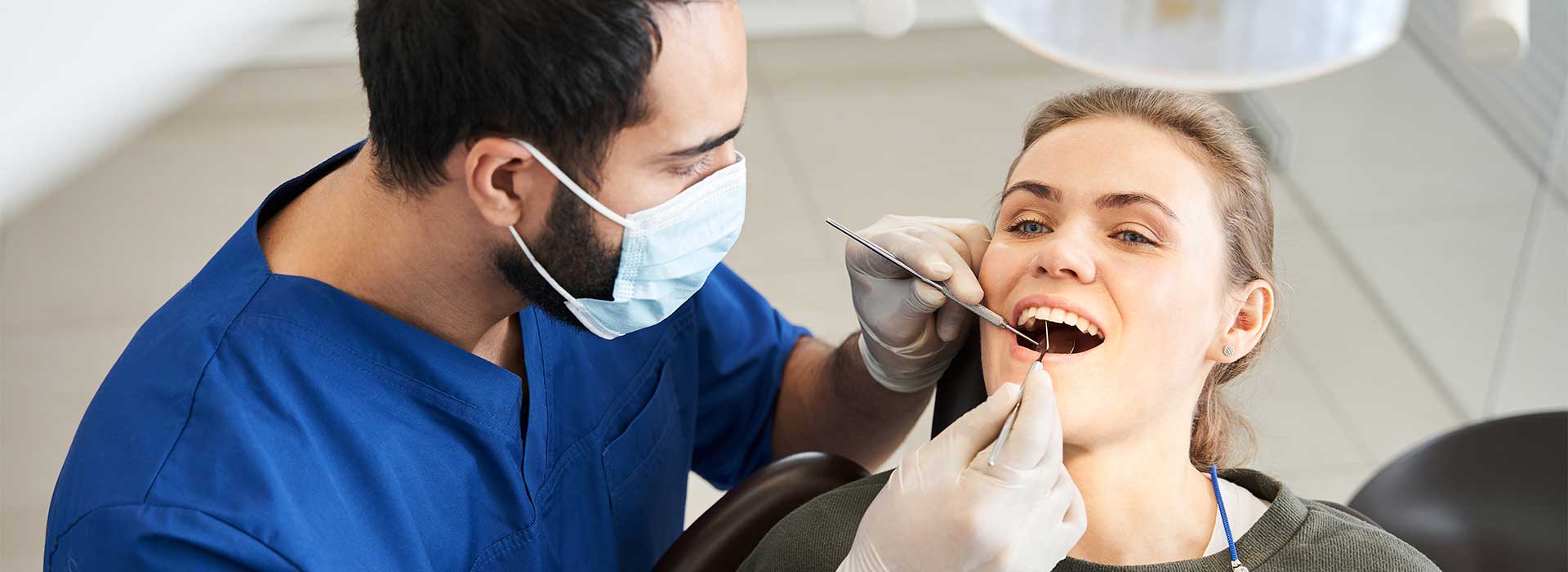 Dentist doing a emergency dental treatment for his patient
