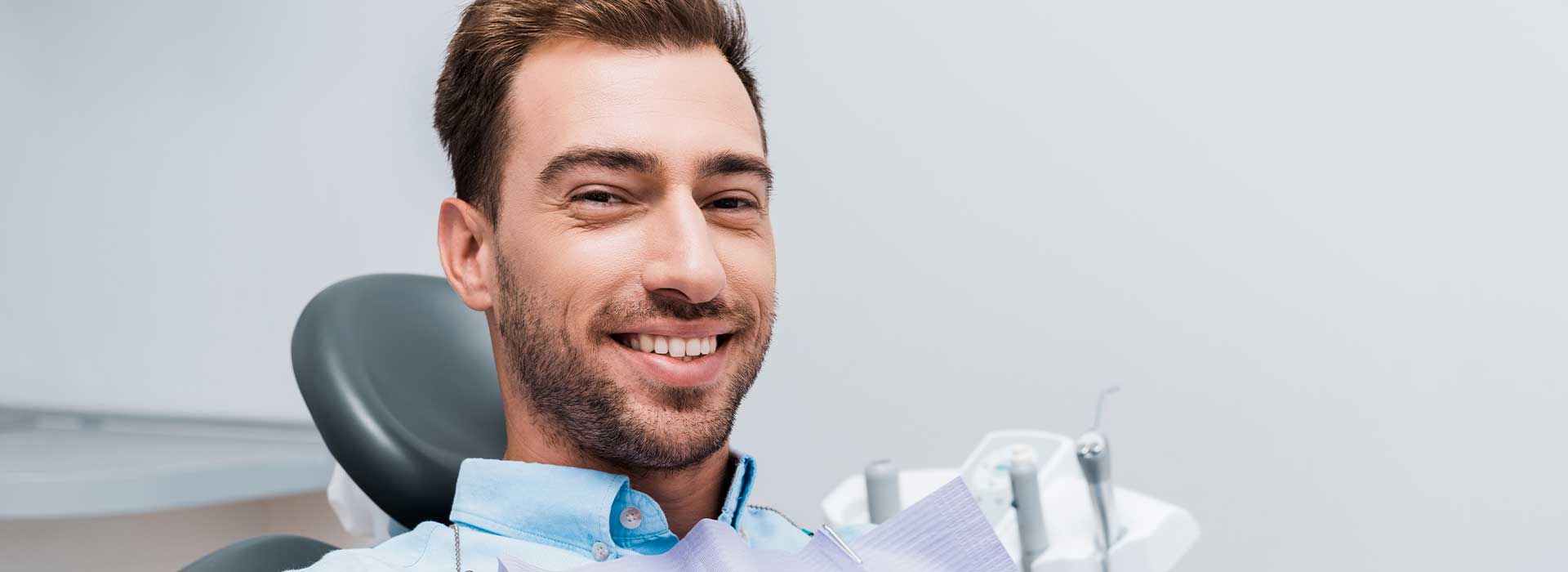 Handsome man smiling at dental