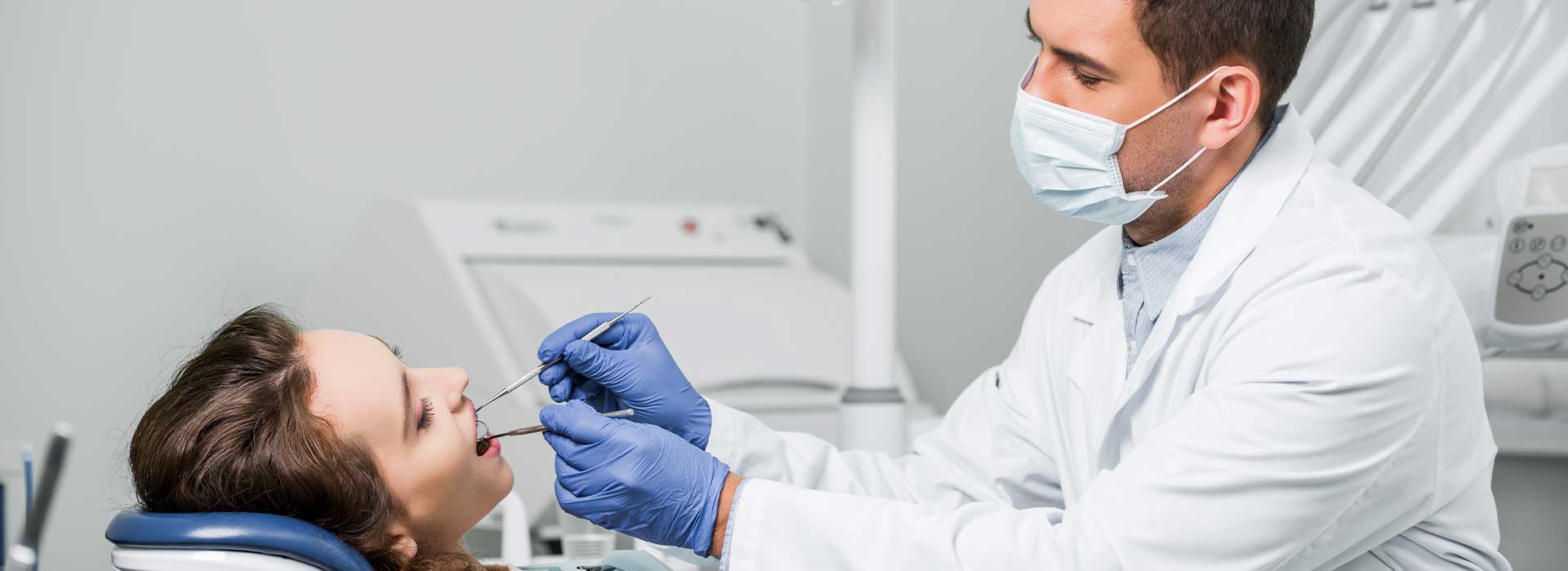 Dentist doing a restoration dentistry for his patient