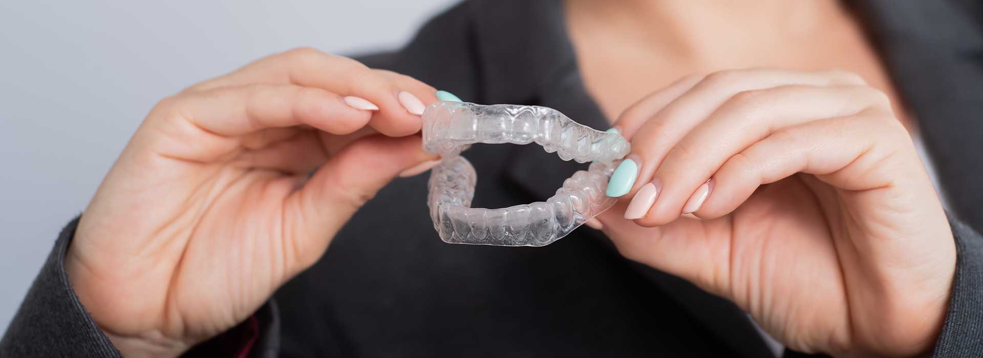 Woman showing dental Occlusal guards